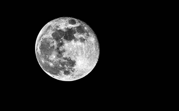 A bright full moon showing detailed craters against a black sky.